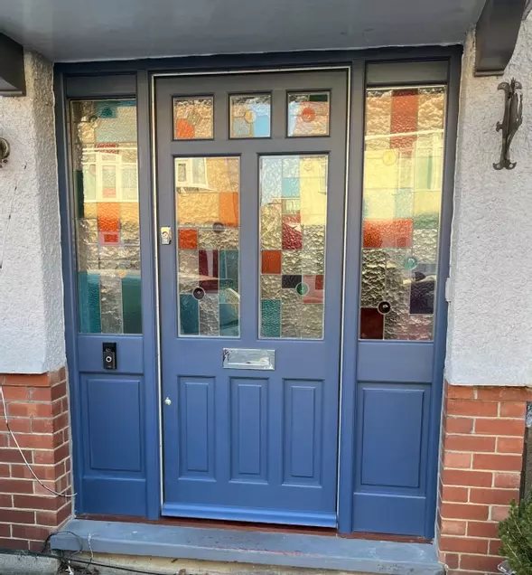 Hardwood door and frame. Traditional stained glass units